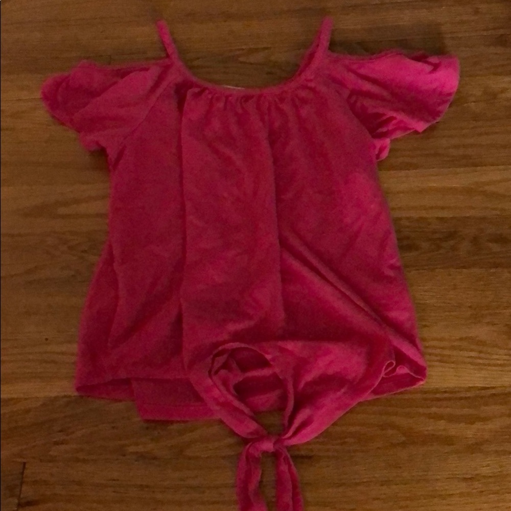 A hot pink off- the shoulder shirt.